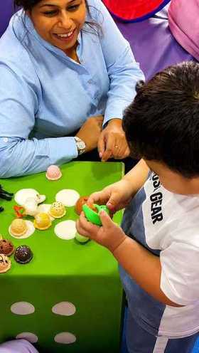 Therapist and toddler playing an ice-cream matching game during early intervention therapy at Starwalkers Clinic Dubai